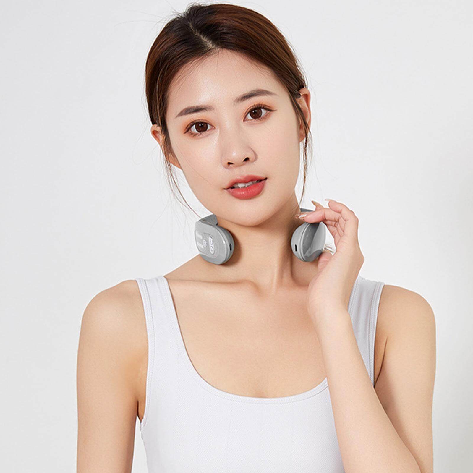 Young woman using EMS neck massager with heat, showcasing innovative design for relaxation and muscle stimulation.