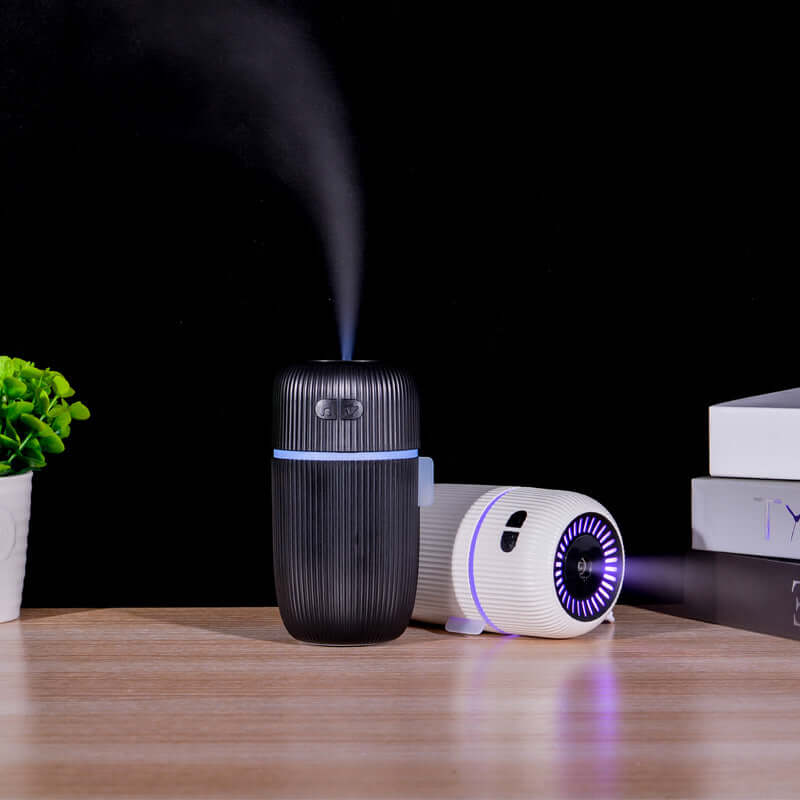 Sleep Aid white noise humidifier for sleep in black and white design on table with green plant.