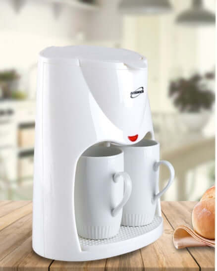 Double cup automatic coffee machine with two coffee cups ready for brewing fresh coffee.