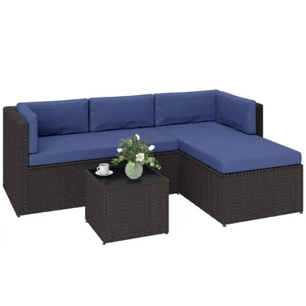 Stylish outdoor patio furniture set featuring a dark wicker chaise lounge with blue cushions and a matching coffee table.