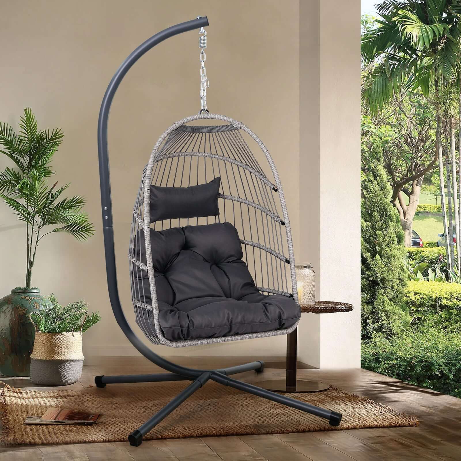 Outdoor egg hanging chair with stand featuring a modern design, black and gray color scheme, perfect for patio and garden.
